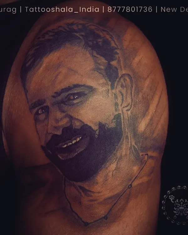 A healed portrait tattoo of a client's loved one. We take pride in creating realistic portraits that stand the test of time. The shading and detail here are crucial for capturing a true likeness.