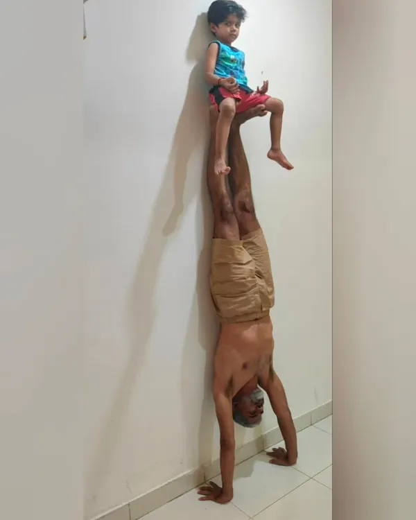 A moment of father-son acro yoga. Balancing my son on my feet during a handstand is a beautiful exercise in trust, strength, and connection. What title would you give this?