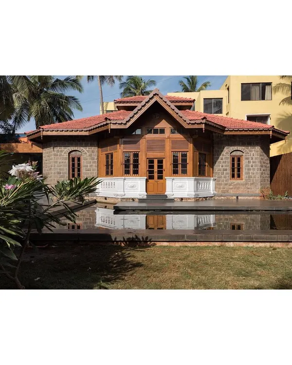 The restored colonial building at the KLE Centenary Museum, viewed across the lotus pond. Our intervention preserved the original stone and timber facade while integrating it into a newly designed plaza that serves the public.