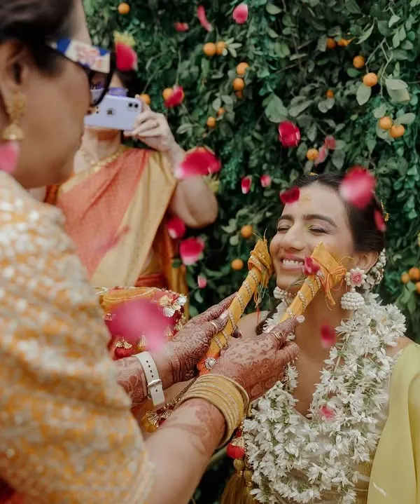 A beautiful, candid moment from a Haldi brunch. We used seasonal clementines and fresh roses to create a vibrant green backdrop, putting a fresh twist on the traditional yellow Haldi decor.