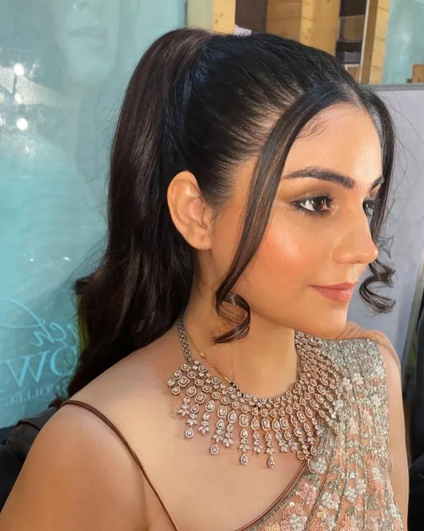 A clean and modern party look is always in style. Here, the focus is on flawless skin, sharp winged eyeliner, and a sleek ponytail, making it a perfect choice for a cocktail party or a formal dinner.