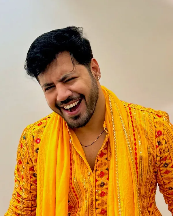 A candid laugh in a bright yellow mirror-work kurta, perfect for a vibrant Haldi or Mehendi ceremony.