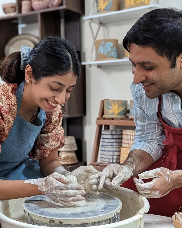 A perfect 'clayful date'. Sharing a laugh while learning something new together on the potter's wheel is a wonderful way to connect.