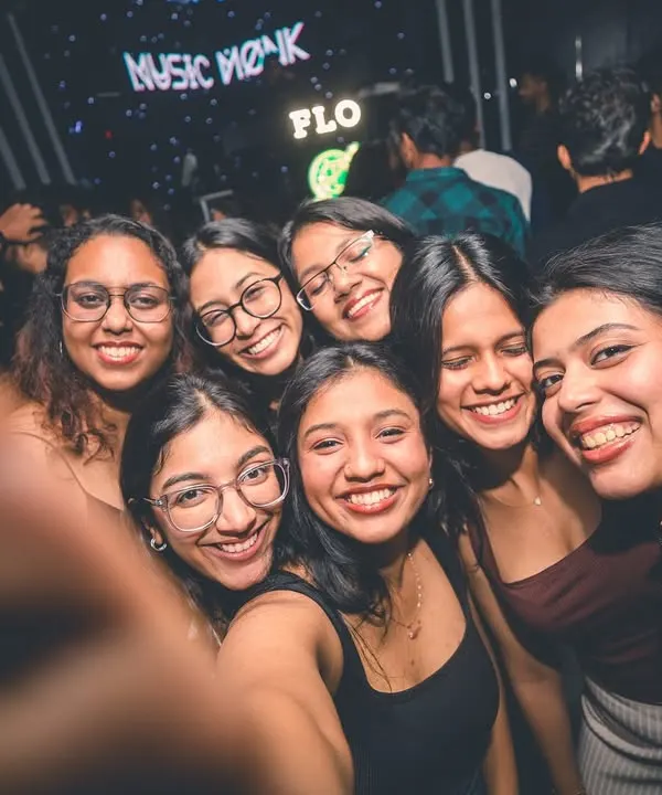 A group of friends taking a happy selfie on the dance floor. My goal is to create the perfect backdrop for your memories.