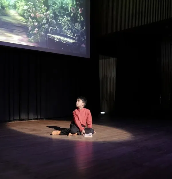 This single spotlight captures the essence of our work. It's that moment when a child, once hesitant, stands alone on stage and owns their space with newfound confidence. This is the transformation we nurture, one class at a time.
