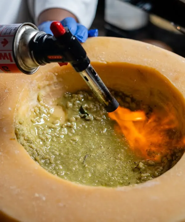 We believe food is theatre. Our live flaring parmesan wheel is a dramatic and delicious experience, where hot, hand-pulled pasta is tossed in a wheel of aged parmesan, creating an unforgettable centerpiece for your event.