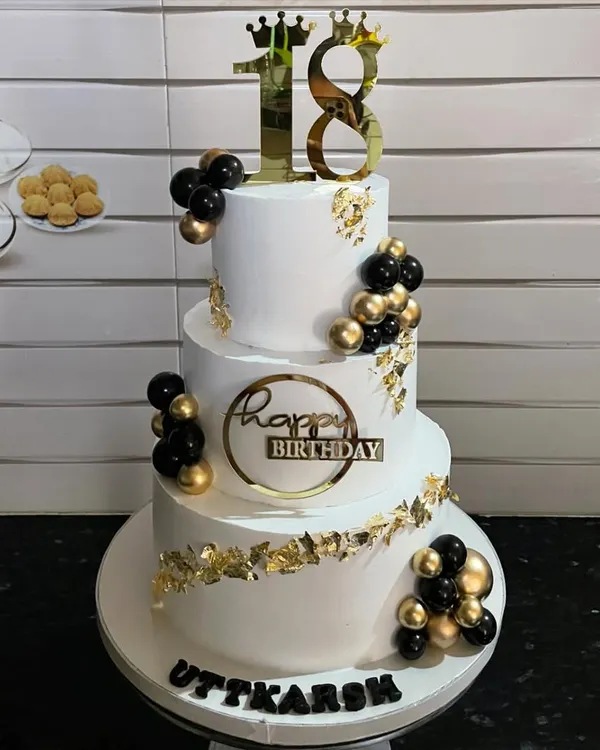 This three-tiered eggless cake was the star of an 18th birthday party. I used a clean white fondant base, accented with black and gold spheres and delicate gold leaf for a touch of modern elegance. It’s a perfect example of a showstopper cake for a major milestone celebration.
