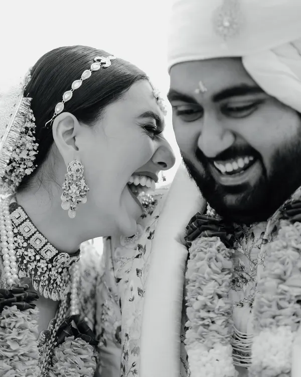 The purest form of joy captured in a timeless black and white frame. This candid photograph of the couple's unrestrained laughter during their wedding ceremony is a perfect example of the unscripted, real moments I strive to capture.