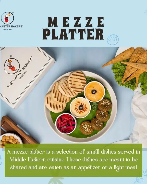 Our Mediterranean Mezze Platter is perfect for sharing. It includes crispy falafel, creamy hummus, a tangy dip, pickled vegetables, and warm grilled pita bread, offering a variety of flavors and textures.