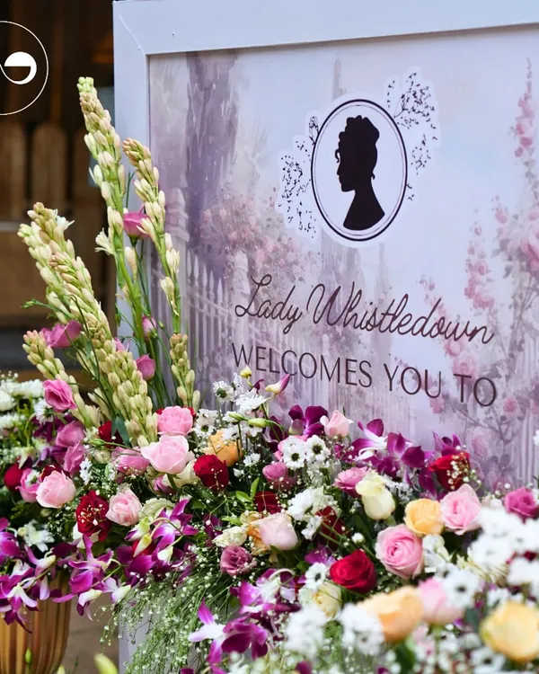 "Lady Whistledown welcomes you." This elegant sign, surrounded by a lavish arrangement of roses, orchids, and tuberoses, set the perfect tone for a sophisticated Bridgerton themed baby shower.