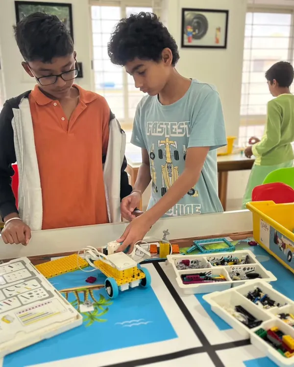 We believe in learning by doing. Here, two of our students are deep in concentration, preparing their robot for the World Robot Olympiad. It's this focus and teamwork that builds not just robots, but also confidence and critical thinking skills.