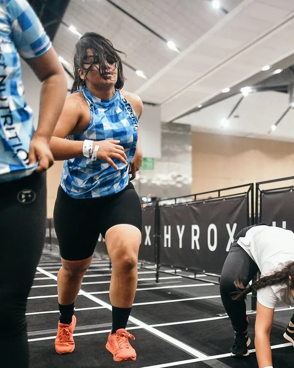 An action shot from the Hyrox Delhi competition. This event is the ultimate test of functional fitness, combining running with various strength stations.