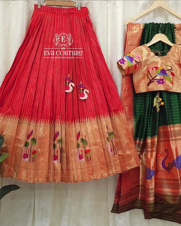 A complete pure Paithani silk lehenga set. The red pleated skirt and golden blouse with woven motifs are paired with a beautiful green Paithani dupatta.