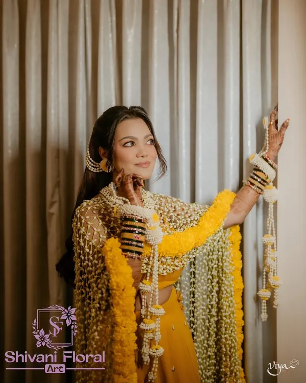 This is the look that makes a Haldi ceremony unforgettable. I designed this complete set, including the intricate floral dupatta made of fresh Tagar buds with a marigold border, heavy floral kalire, and matching jewellery, to make my bride feel like royalty on her special day.