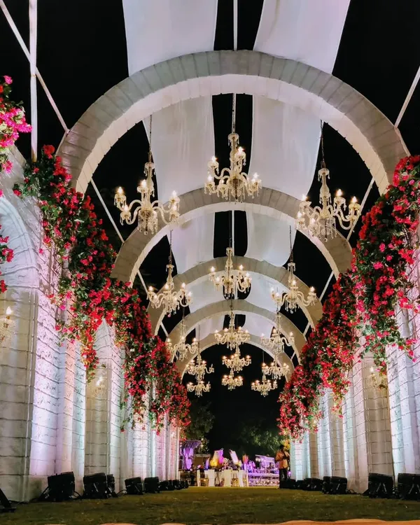 I believe a wedding should begin with a sense of wonder. This grand palatial entrance, with its cascading floral arches and crystal chandeliers, was designed to be more than just a doorway; it was the start of a fairytale, promising a night of unforgettable royal splendor.