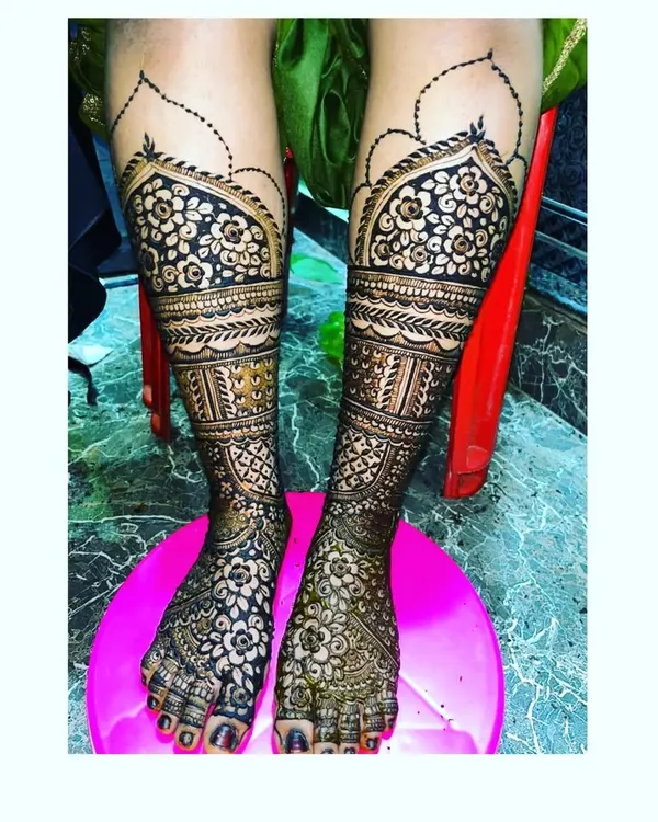 A stunning example of heavy bridal mehendi for the legs. This design features intricate floral and geometric patterns that provide full coverage.