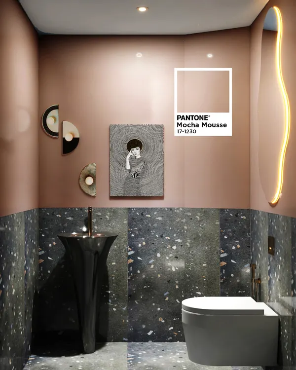 This powder room makes a bold statement with "Mocha Mousse" colored walls paired with dark terrazzo tiles. The unique pedestal sink and abstract mirror add an artistic flair.