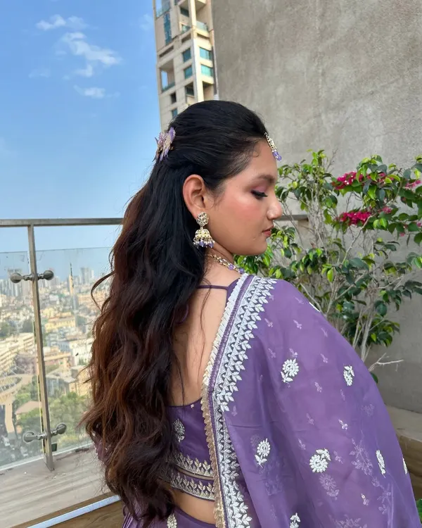 This effortless half-up hairstyle with soft waves is perfect for when you want a look that's special but not overly formal. The butterfly clips add a whimsical touch.