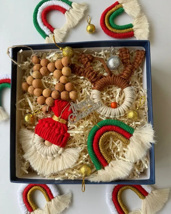 My curated Christmas ornament gift box is perfect for friends and family. It includes a macrame reindeer, Santa, rainbow, and wooden bead garland, all ready for the tree.