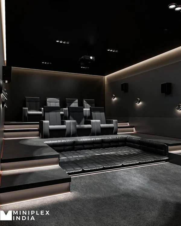 A side view of our 'Shadow Luxe' project, highlighting the clean lines of the tiered seating platform with integrated step lighting. The design ensures every seat has an unobstructed view, while the dark, non-reflective surfaces minimize light bleed and enhance on-screen contrast.