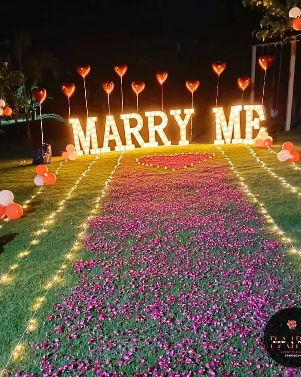 I create dream proposal setups like this one, featuring a pathway of rose petals and glowing "MARRY ME" letters to make your special moment absolutely perfect. This outdoor marriage proposal decoration is designed to be both romantic and unforgettable.