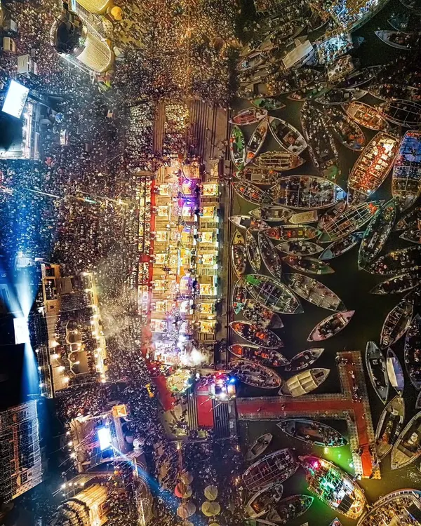 A breathtaking top-down view of the Ganga Aarti in Banaras. This image captures the scale of devotion, with thousands of lamps lighting up the ghats and countless boats filling the sacred river.