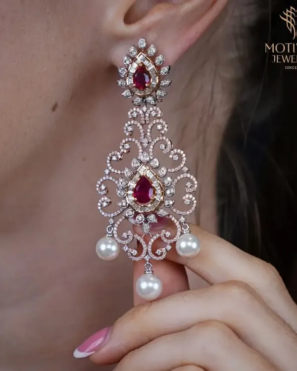 The pinnacle of glamour. These chandelier earrings feature a breathtaking design of rubies, diamonds, and pearls, crafted to create a statement of pure luxury and intricate artistry.
