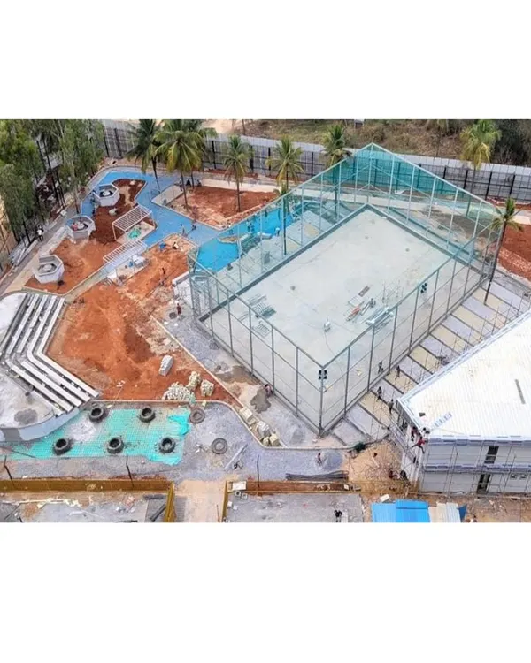 An aerial shot of the Vaishnavi Tech Square site during construction. This view shows the foundational layout of the sports court, amphitheater, and pathways, giving a sense of the project's scale.