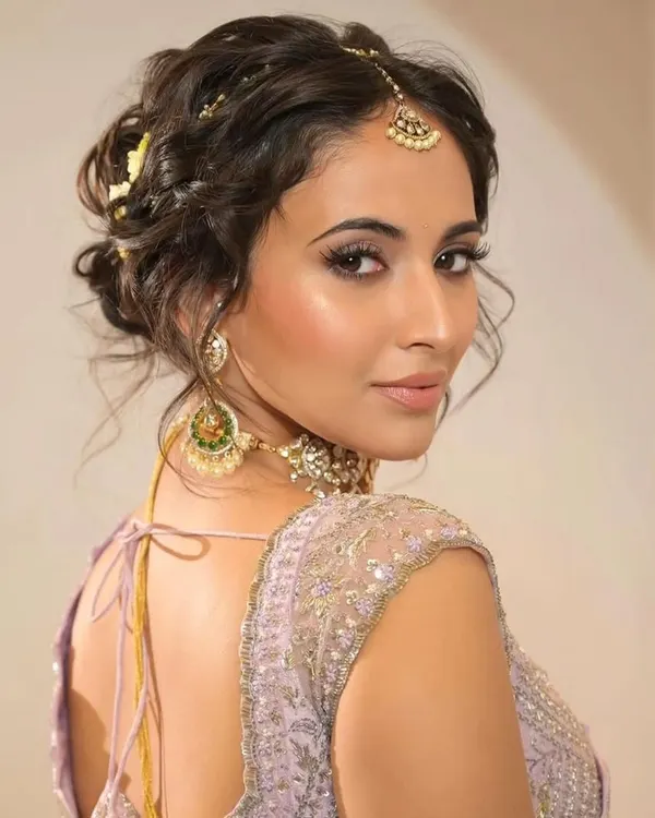 This tousled, textured updo is one of the most requested bridal hairstyles. It's romantic, modern, and can be customized with flowers or accessories to match any outfit.