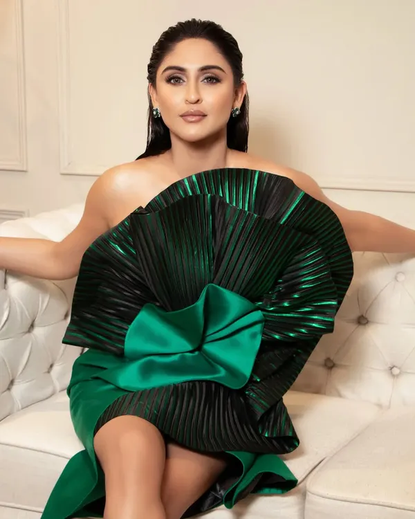 A direct, stunning shot of Krystle D'Souza. The makeup features a flawless base, contoured features, and a sharp winged liner that holds its own against the dramatic silhouette of her gown.
