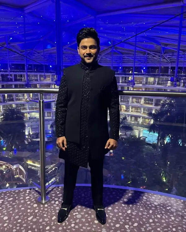 A striking blue Indo-Western outfit perfect for an evening reception. The jacket and sleeves feature intricate salli work, creating a textured and modern look.