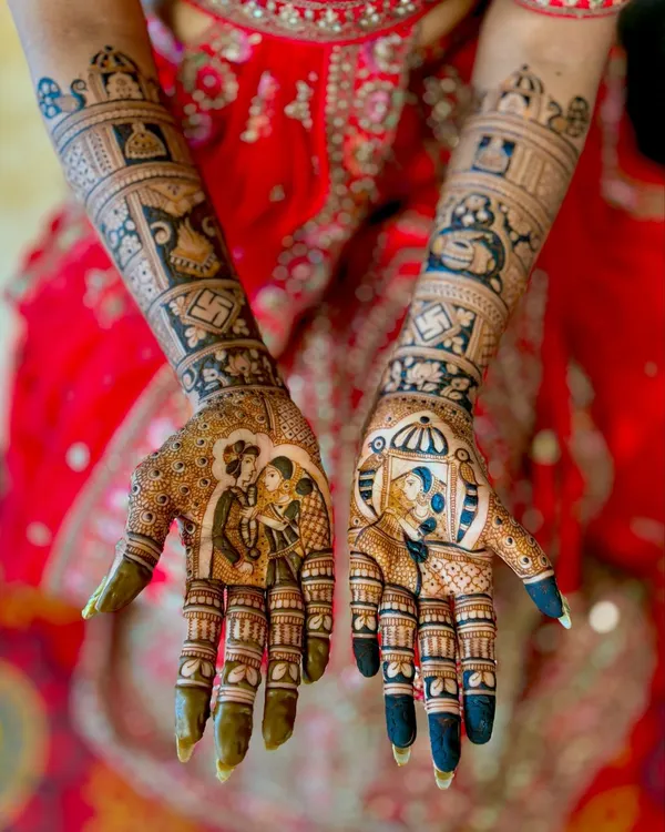 This is what I mean by mehendi that tells your story. This full bridal design features custom portraits of the couple, capturing a special moment for them to cherish. The surrounding patterns are filled with traditional motifs, all drawn with organic henna for a deep, beautiful stain.