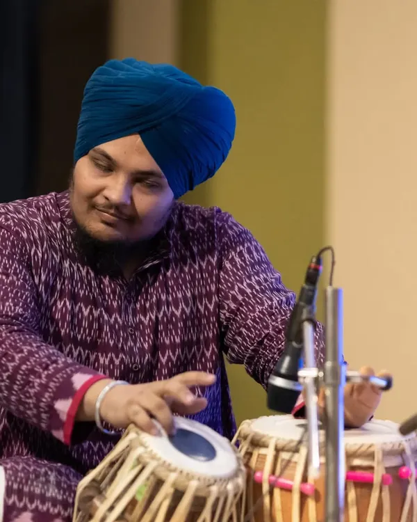 A focused moment during a live concert. This photo captures the concentration required to perform on stage, connecting with the music and the audience.