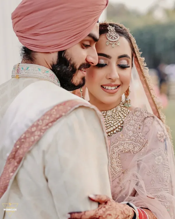 An intimate and heartfelt portrait of a Sikh couple. The soft smiles and gentle embrace capture the beautiful connection they share on their wedding day.