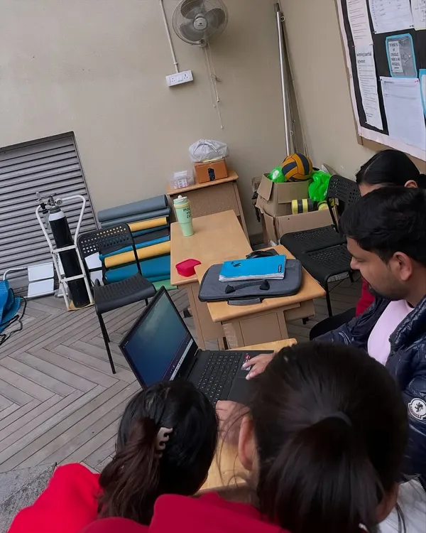A typical poolside session involves more than just swimming. Here, we are reviewing race footage and performance data to identify areas for technical improvement.