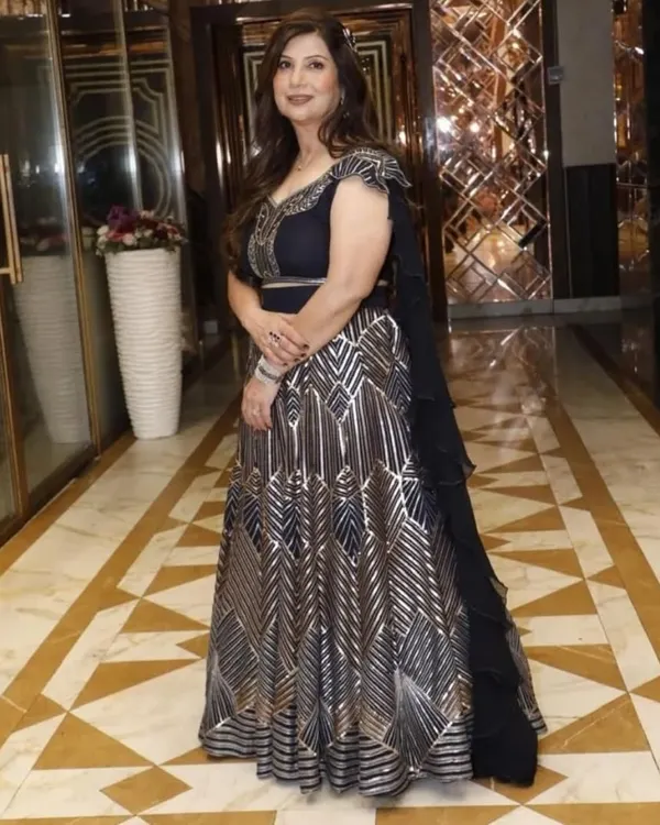 A full-length view of this exquisite black and silver gown, showcasing its beautiful flare and intricate pattern. It's a perfect example of a premium designer dress for a grand evening affair.
