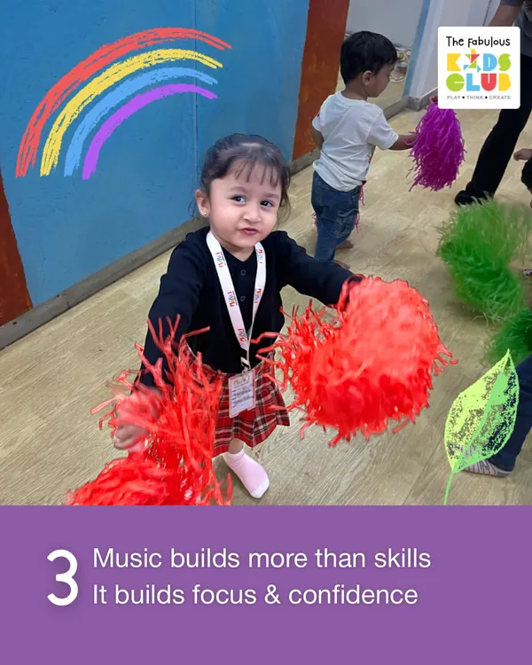 Music does more than just build skills; it builds focus and confidence. This little one is fully engaged with her pom-poms, learning to follow the rhythm and participate in a group setting.