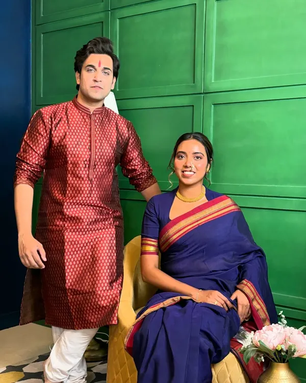 A professional portrait from a brand shoot featuring a classic Marathi look. I'm posing with my co-model, creating a scene that feels authentic and culturally rich, perfect for festive campaigns.