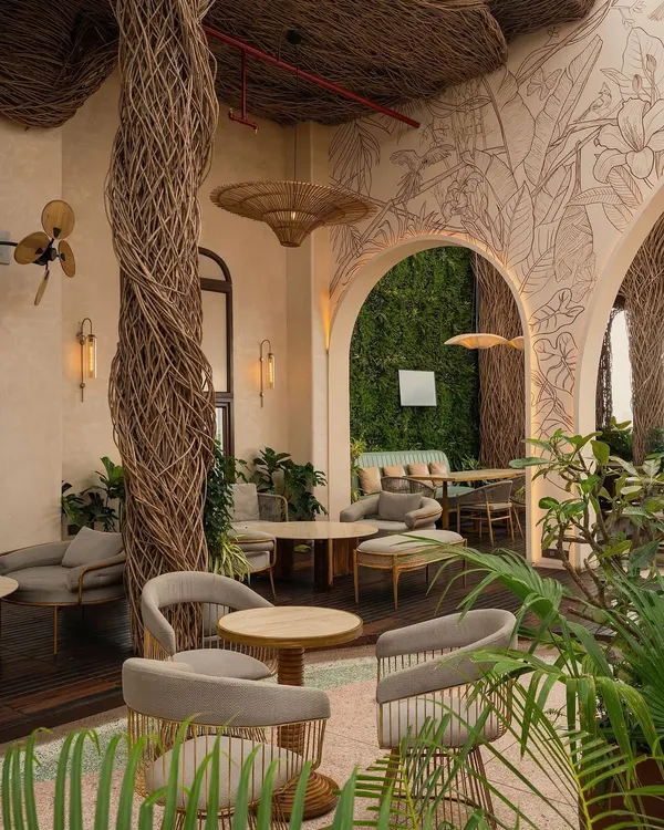 Welcome to Nido, a rooftop restobar where we turned an ecological challenge into architectural poetry. The canopy is handwoven from lantana twigs, an invasive shrub, creating a warm, cocoon-like escape above the city. This project represents our passion for sustainable innovation and artisanal craftsmanship.