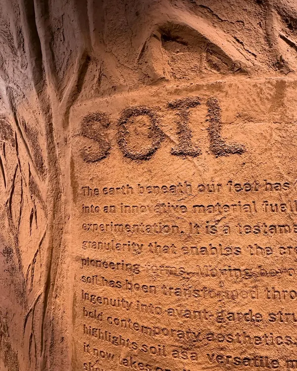 We believe material is a medium for storytelling. This close-up of our 'Soil' installation for ColourNext reveals text debossed into an earthen texture. It highlights our focus on the tactile and sensorial, transforming a raw material into an artistic and communicative surface.