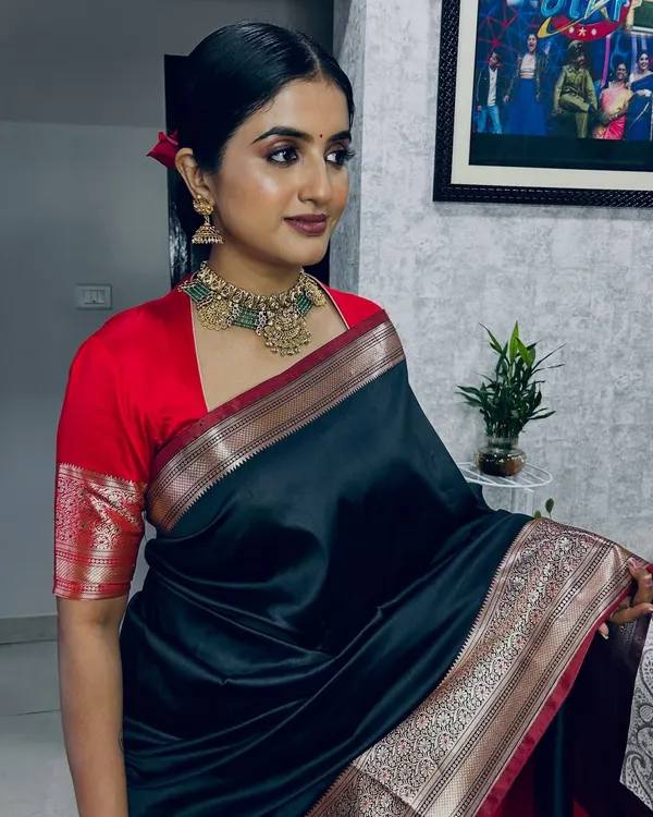 This is one of my favorite classic looks for a photoshoot. I created a defined, smoky eye and a bold lip to complement the beautiful black and red silk saree, ensuring the makeup was flawless and camera-ready under studio lights.