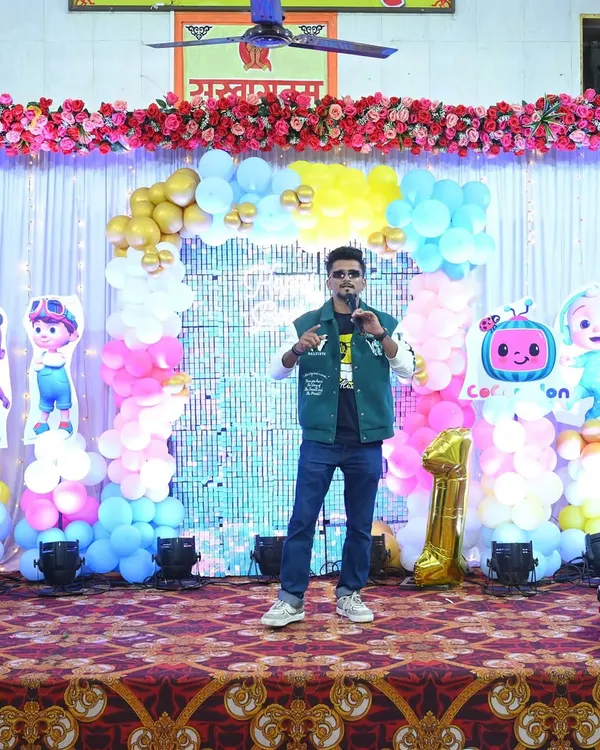 Posing on stage before hosting a fun-filled first birthday party. The Cocomelon theme was a big hit with the kids.