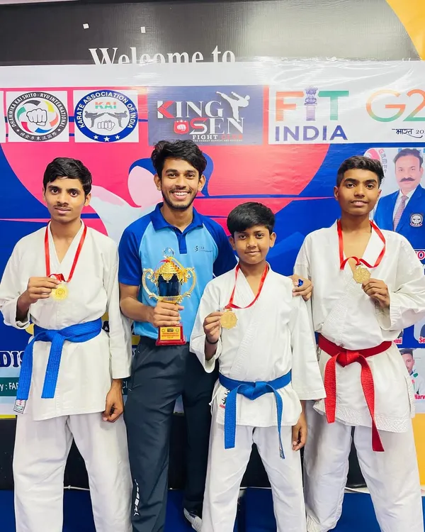 Standing proud with my champions and our team trophy. Each medal around their necks represents countless hours of hard work and dedication in our karate classes.
