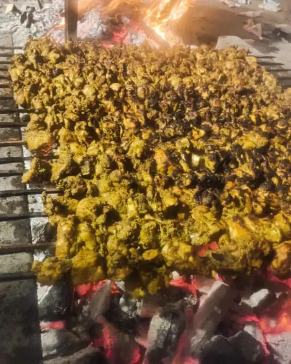 This is how we cater for a large crowd. Hundreds of chicken tikka pieces being grilled at once over hot coals.