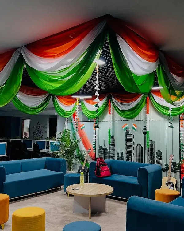 I transformed this entire office common area with a grand tricolor fabric ceiling drape for a national holiday celebration. This kind of large scale decoration creates an immersive and patriotic atmosphere for employees.