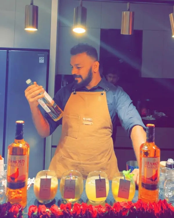 Here I am preparing a smoked whisky cocktail using The Famous Grouse. The technique involves using a Flavour Blaster to infuse the drink with an aromatic cloud, adding a dramatic flair to our mixology services.