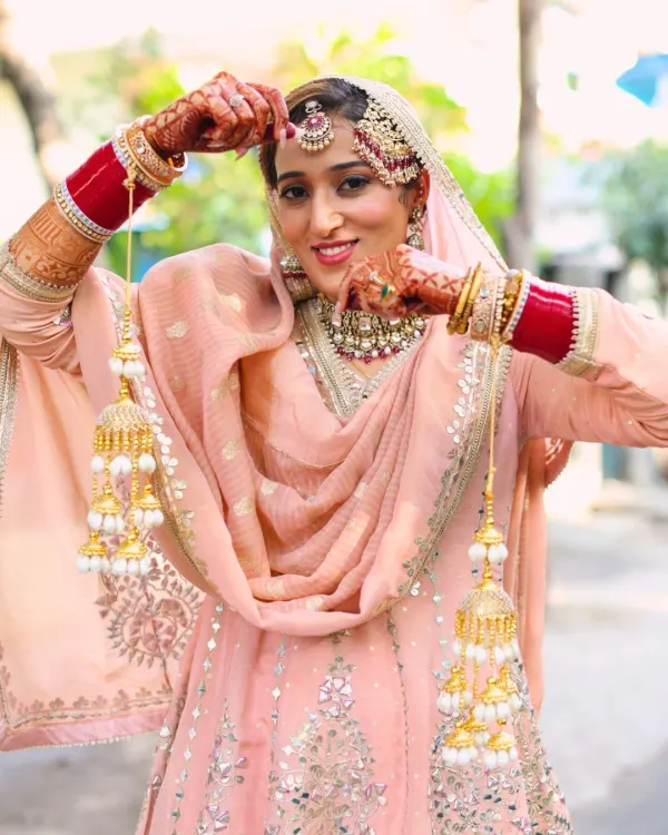 This Punjabi bride is the picture of grace in her pastel peach suit. I created a soft glam look with a focus on radiant skin and defined eyes to complement her elegant and modern outfit.