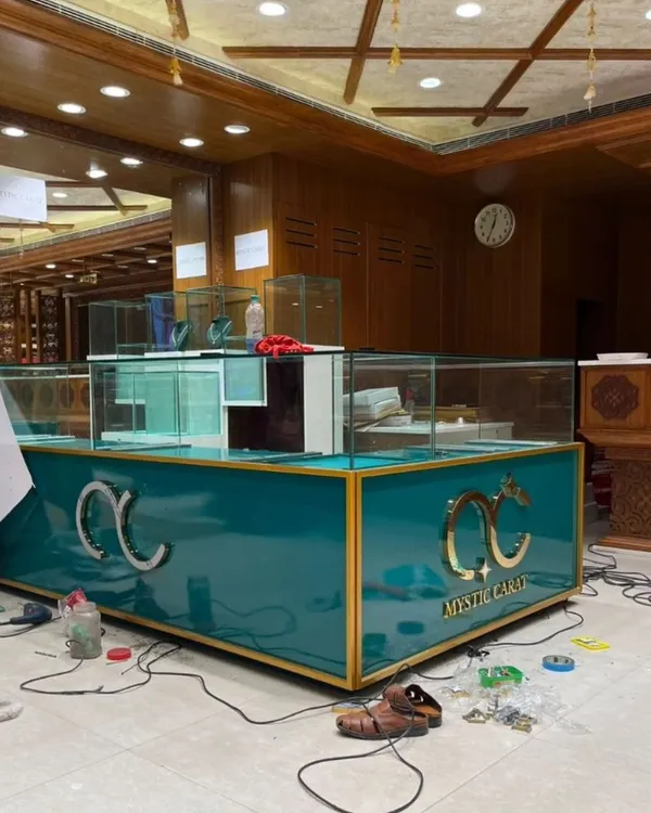 The final setup for the Mystic Carat jewelry store, featuring a custom-built teal and gold counter. The design combines luxury materials and strategic lighting to create a high-end retail experience that makes the products shine.
