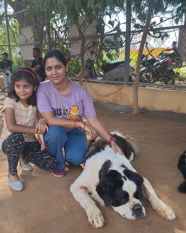 A mother and daughter posing with our gentle St. Bernard, a perfect family outing.