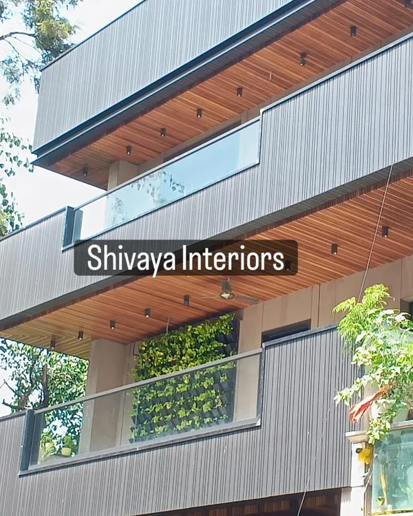 A finished view of a modern residential facade. I balanced the design with dark grey vertical cladding against the natural wood finish of the soffit panels under the balconies, creating depth and visual interest.